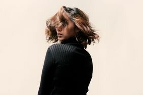 Person with a wavy bob doing a head twist