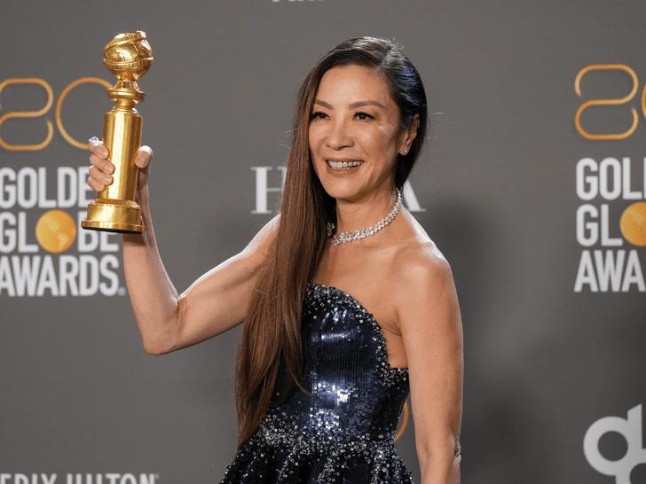 Michelle Yeoh holding her golden globe