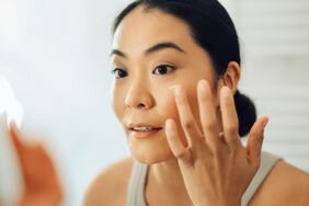 Person applying retinol to their face