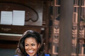 Michelle Obama wearing an electric blue Elie Saab suit with bright accent stripes