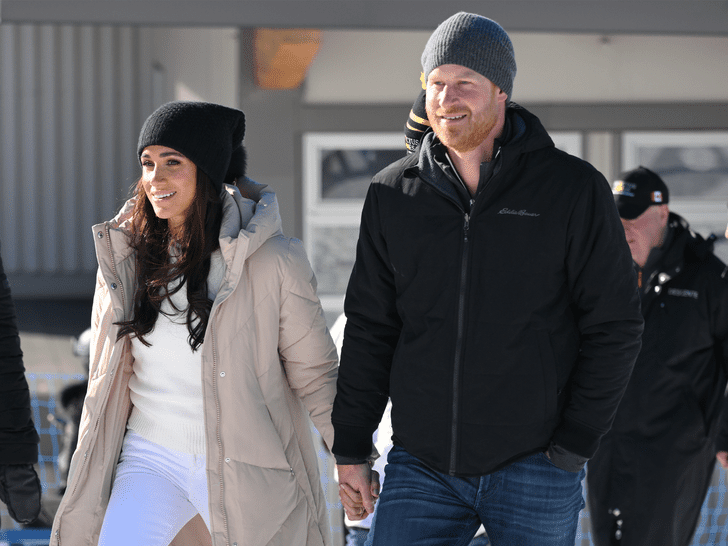 Prince Harry and Meghan Markle attend the Invictus Games in coats and hats