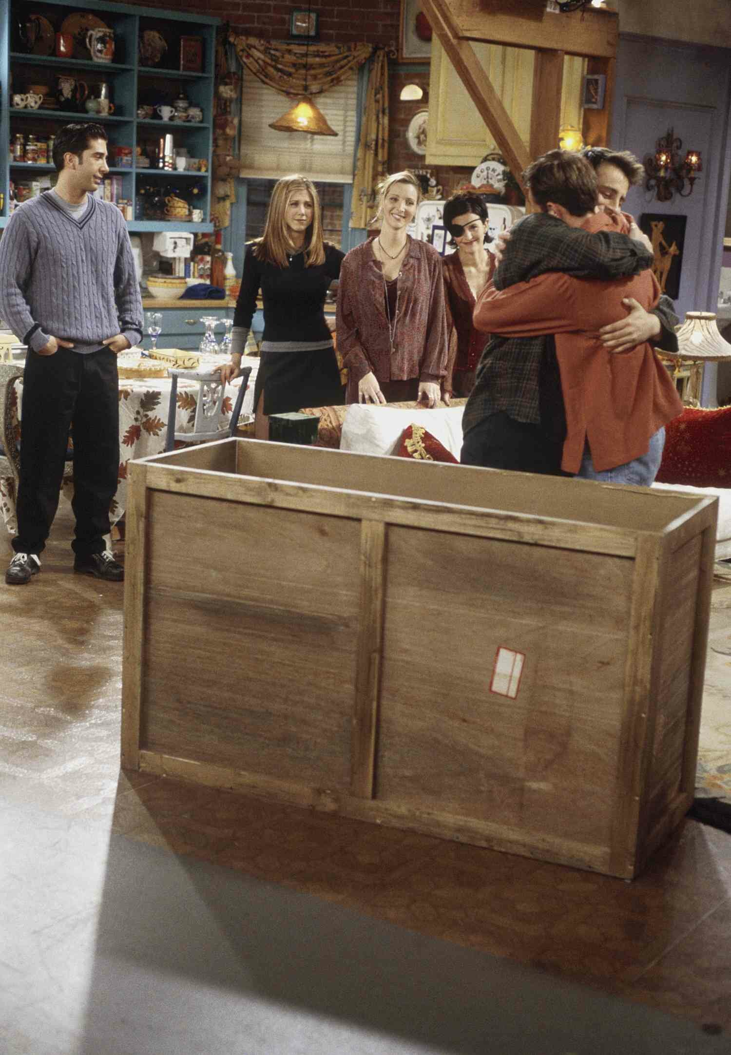 Chandler Bing and Joey Tribbiani Hugging Outside of Chandler's Box