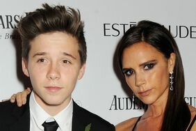 Brooklyn Beckham (L) and Victoria Beckham arrive at the Harper's Bazaar Women of the Year awards at Claridge's Hotel on November 5, 2013 in London, England.