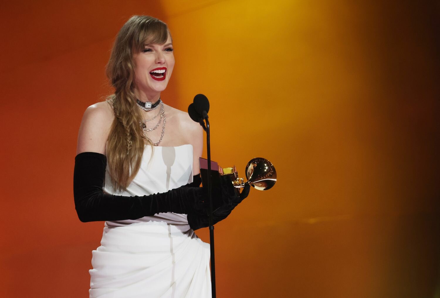 Taylor Swift Smiling on Stage Holding Golden Gramophone 2024 Grammys